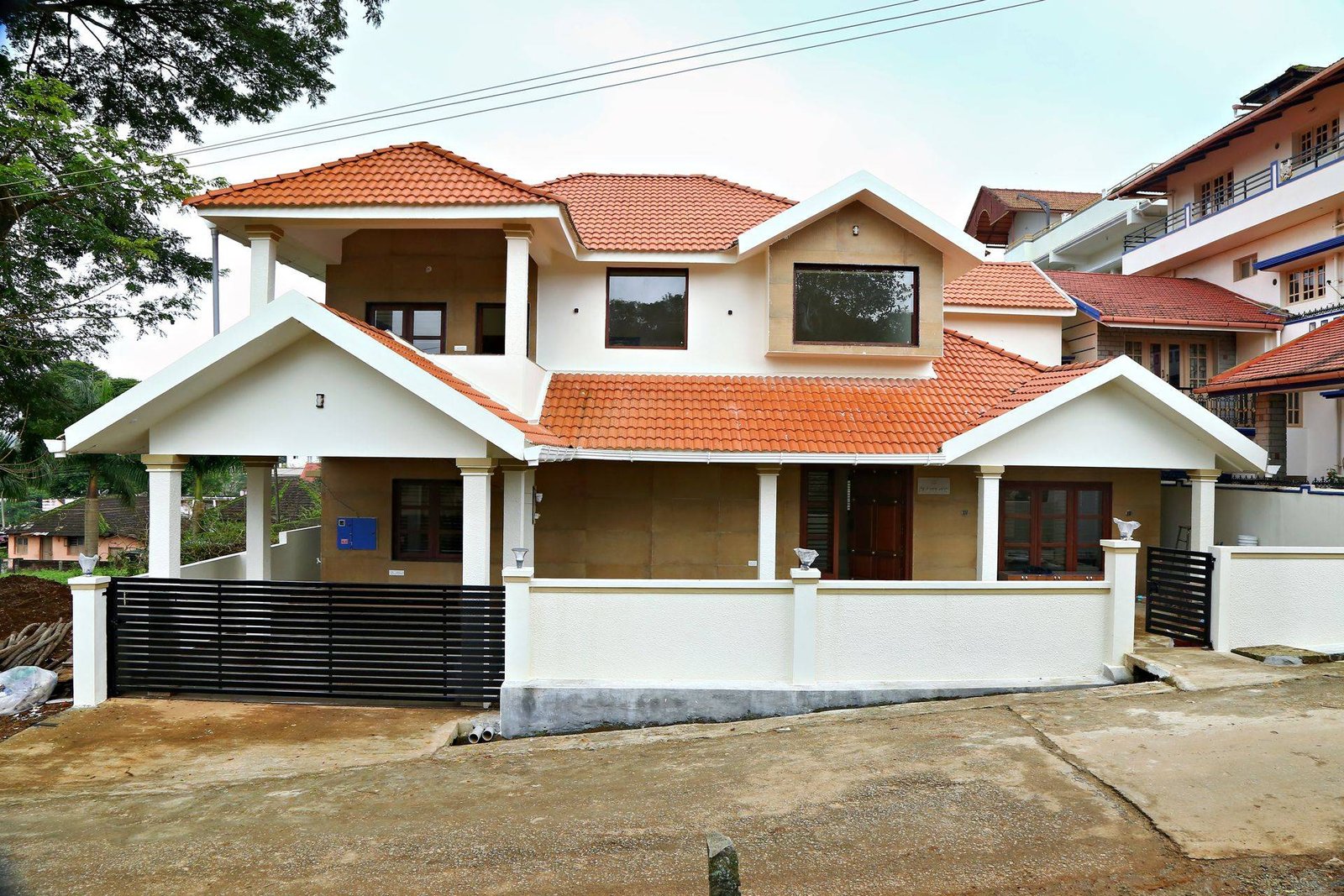 Duplex house with clay-tile roof, portico and compound wall completed by Matrix Realty
