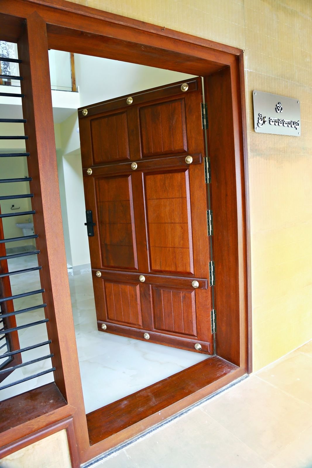 Solid teak main door with brass studs